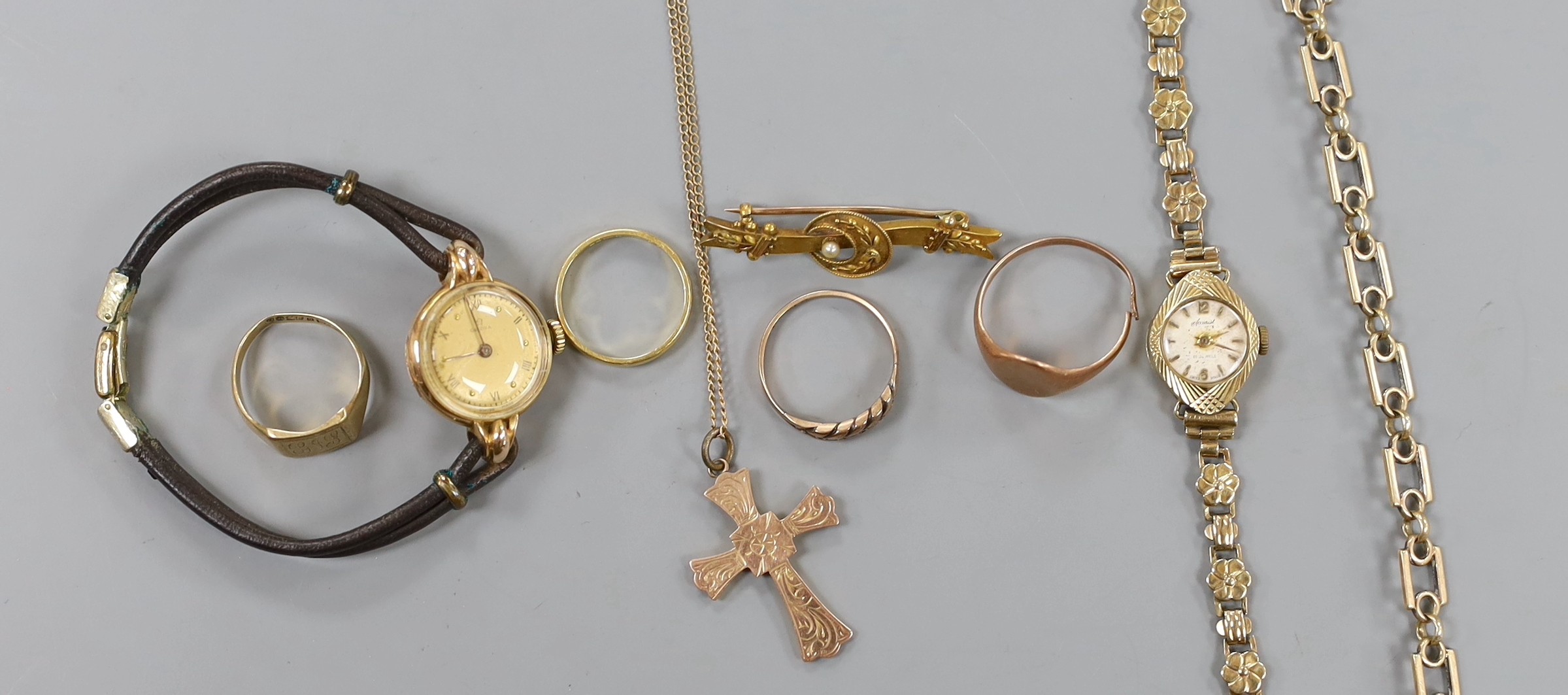 A lady's 9ct gold Accurist manual wind wrist watch, on a 9ct gold bracelet, gross weight 11.2 grams, one other lady's yellow metal wrist watch, three 9ct gold rings, a 9ct gold bracelet, a 9ct cross pendant on 9ct chain,
